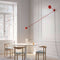 luceplan-counterbalance-red-wall-lamp-over-table | ikonitaly