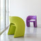 a pistacchio green raviolo chair and a purple chair ina an empty room | ikonitaly