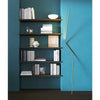 nemo neo leaning floor lamp gold next to bookshelf