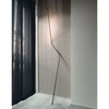 nemo neo leaning floor lamp next to black curtain