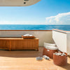 two brown leather baskets on a yacht with water in the background