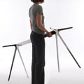 person lifting magia baguette table legs | ikonitaly