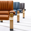 Detail of the Supercomfort armchair’s curved oak armrest and precision stitching on the leather upholstery.