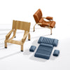 Close up of the Supercomfort armchair showing the padded leather cushion and finely crafted oak wood joinery.