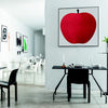 uno, la mela a silkscreen print in a black frame hung on a white wall in an office