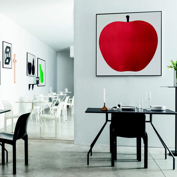 uno, la mela a silkscreen print in a black frame hung on a white wall in an office
