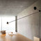 luceplan-counterbalance-black-wall-lamp-over-table | ikonitaly