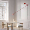 luceplan counterbalance red wall lamp over table