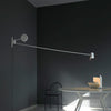 luceplan counterbalance white wall lamp over table