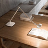 luceplan otto watt slim table lamp white on desk book