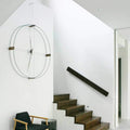 nomon-delmori-hanging-design-wall-clock-near-stairway | ikonitaly