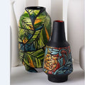 Vase with embossed stripes and vase tropical in background