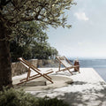   two-atmosphera-nirvana-folding-teak-deck-chairs-near-sea | ikonitaly