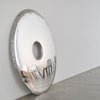 stainless steel mirror on the floor leaning on a wall